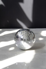 Silver disco ball in the morning sun