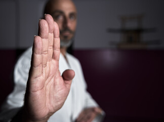 Obraz premium Karate master with focused hand and unfocused face, posing with powerful attitude in his dojo or karate school