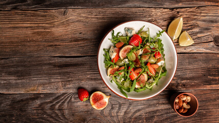 vegetarian salad with rucola, figs, blue cheese, strawberries, grapes, Long banner format. space for text