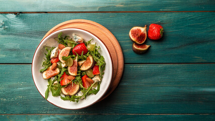 vegetarian salad with rucola, figs, blue cheese, strawberries, grapes, Long banner format. space for text