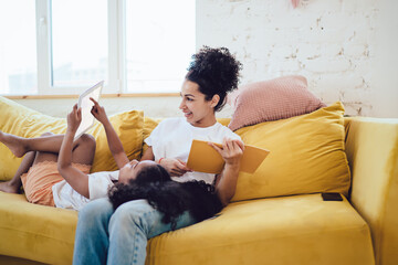 Chilling mother with daughter sharing tablet