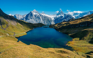Panorama at majestic peaks of Schreckhorn and Wetterhorn and reflection of mountains at Bachalpsee...