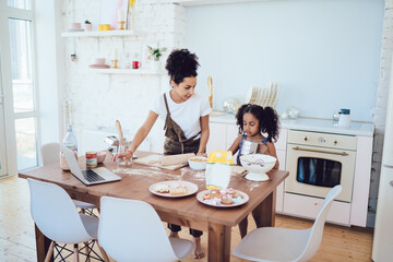 Mother and daughter cooking sweets together