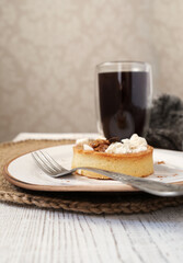 Caramel tart with cup of coffee