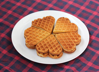 heart-shaped waffles in a white plate.
