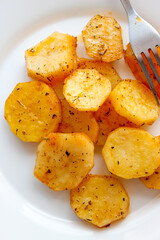 Baked potatoes in the oven in large slices