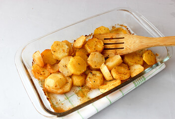 Baked potatoes in the oven in large slices