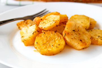Baked potatoes in the oven in large slices