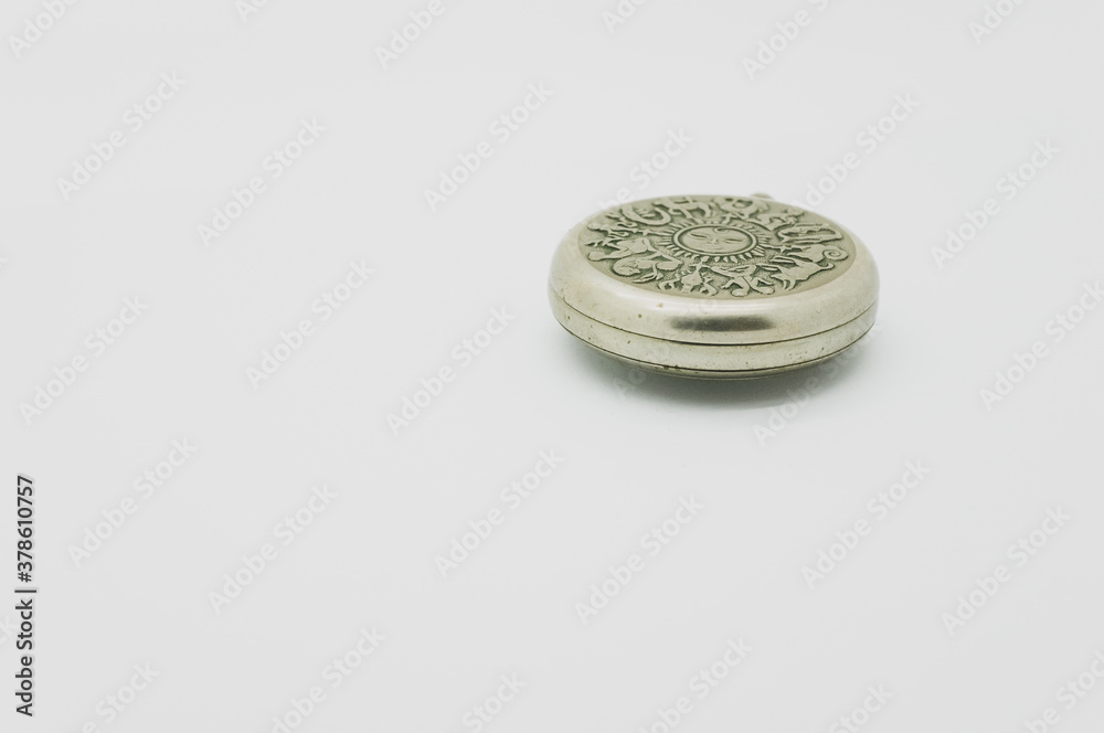 Sticker closeup shot of a vintage silver pocket watch isolated on white background