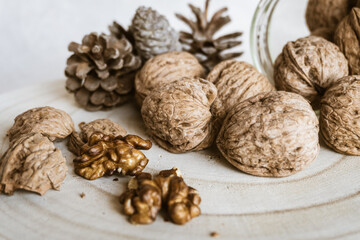 Close up of fresh and whole walnuts on a rustic wooden board.