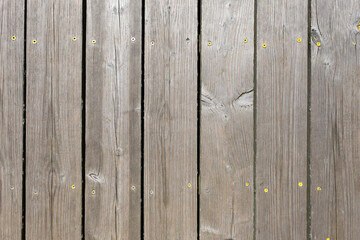 Corroded and damaged seasoned wooden floor plank with scratch marks