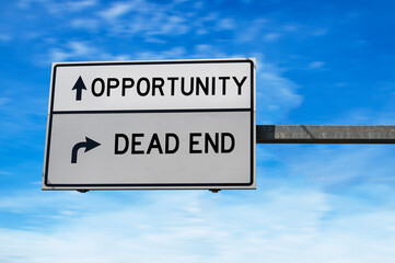 White road sign with words opportunity and dead end against blue sky background.