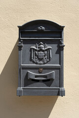 Old red Italian mail box on a wall.