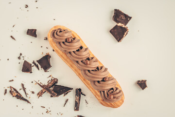 Top view to eclair with whipped cream and chocolate. 