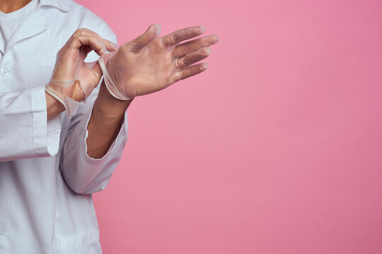 Medical Gown Hands In Transparent Gloves Pink Background Cropped View