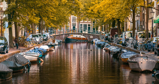 canal and boats in Amsterdam on an autumn day