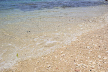 small waves on the beach, with clear water