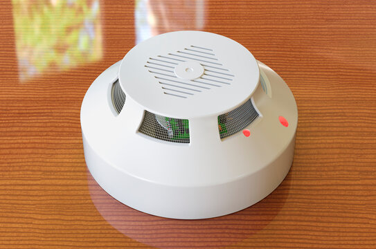 Fire and flame detector on the wooden table. 3D rendering