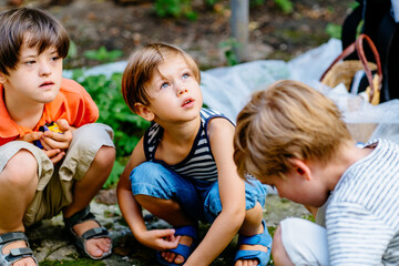 Two children boy working at backyard. Brother with gardening tools spending time, playing, create a cozy courtyard together outdoor at beautiful summer day. developmental activities for children