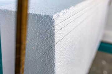 Industrial production of polystyrene foam insulation panels or plates. A large blocks of Styrofoam...