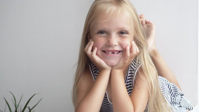 Preschool girl with white hair smiling, portrait