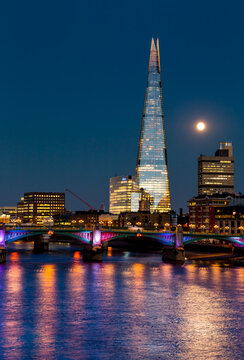 shard in london at night over the thames