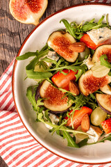 vegetarian salad with rucola, figs, blue cheese, strawberries, grapes,