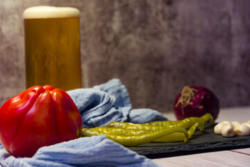 Spanish tapa of beer with chilli peppers, tomatoes and garlic.