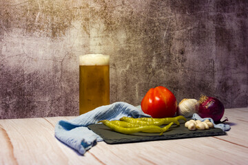 Spanish tapa of beer with chilli peppers, tomatoes and garlic.