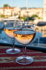 Drinking of local rose wine in summer with sail boats haven of Port Grimaud on background, Provence, France