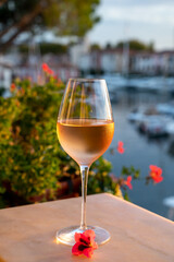 Tasting of local rose wine in summer with sail boats haven of Port Grimaud on background, Provence, France