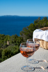 Picnic with of local rose wine and blue Mediterranean sea on background, near Saint-Tropez, Var, Provence, France