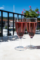 Summer party with sparkling rose champagne wine and sail boats haven of Port Grimaud on background, Provence, France