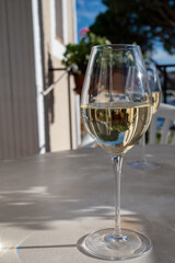 Tasting of local white wine on sunny summer balcony Provence, France