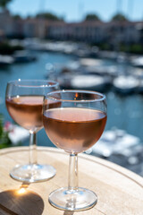 Tasting of local rose wine in summer with sail boats haven of Port Grimaud on background, Provence, France