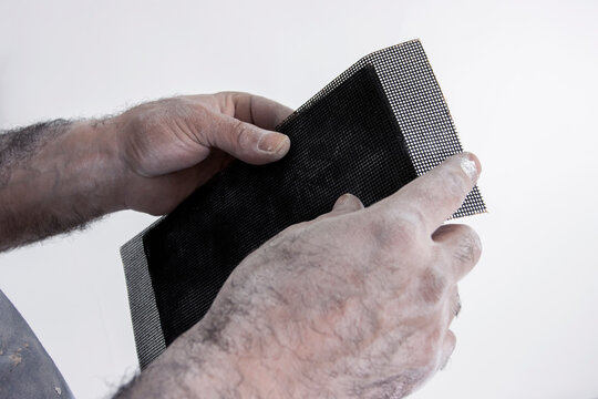 Plaster sandpaper on a hand sanding tool © AKA-RA