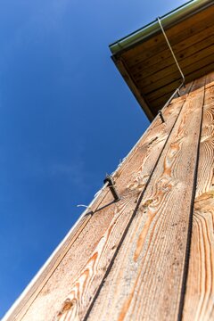 Log Wall Of Modern Wooden House Under Construction. Detail Of Lightning Conductor. Ecological House. Storm Protection.