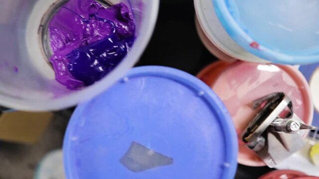 purple screen printing ink paint in cup. top-down view