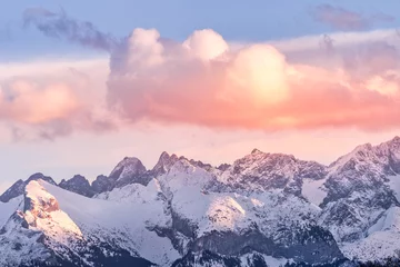 Fotobehang Sunset with dramatic sky and snowy mountain peaks illuminated by sunlight, Tatra Mountains in winter time. Mountain range in Bialka Tatrzanska, Poland © Dawid