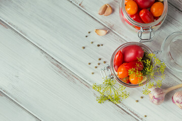 Naklejka na ściany i meble Top view of raw healthy food on white wooden table mockup. Delicious, organic, tasty and ripe tomatoes with seasonings and garlic in glass jar background with copyspace for text.