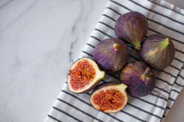 Fresh figs. Food Photo. whole and sliced figs on beautiful rustic background. Fresh Organic Figs.  Healthy Mediterranean fig fruit. Beautiful blue-violet figs with empty copy space close up.