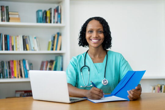 Beautiful african american doctor with file of patient