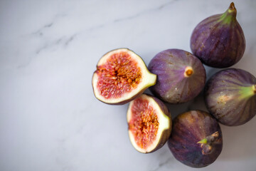 Fresh ripe figs as background, top view. Tropical fruit. Fresh ripe figs with green leaf and on...
