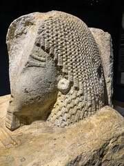 An Egyptian man statue engraved with hieroglyphs
