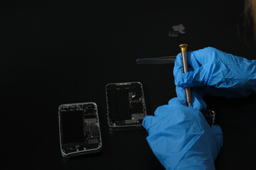 Technician repairing the Cell phone parts and tools for recovery repair phone smartphone and...