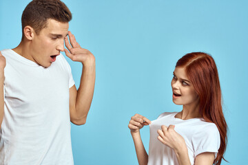 Young woman and man stinks relationship on blue background cropped view of couple in love