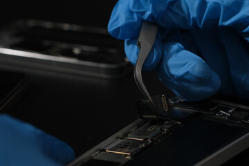 Technician repairing the Cell phone parts and tools for recovery repair phone smartphone and...
