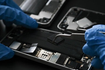 Technician repairing the Cell phone parts and tools for recovery repair phone smartphone and...