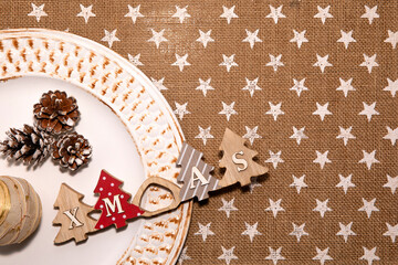 Christmas white plate with trees, balls and hazelnut decoration above, with xmas letters