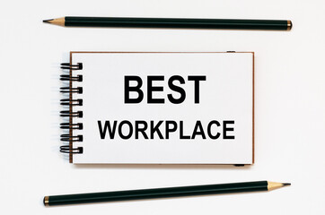 WHITE SPIRAL NOTEBOOK, TWO PENCILS WITH TEXT BEST WORKPLACE